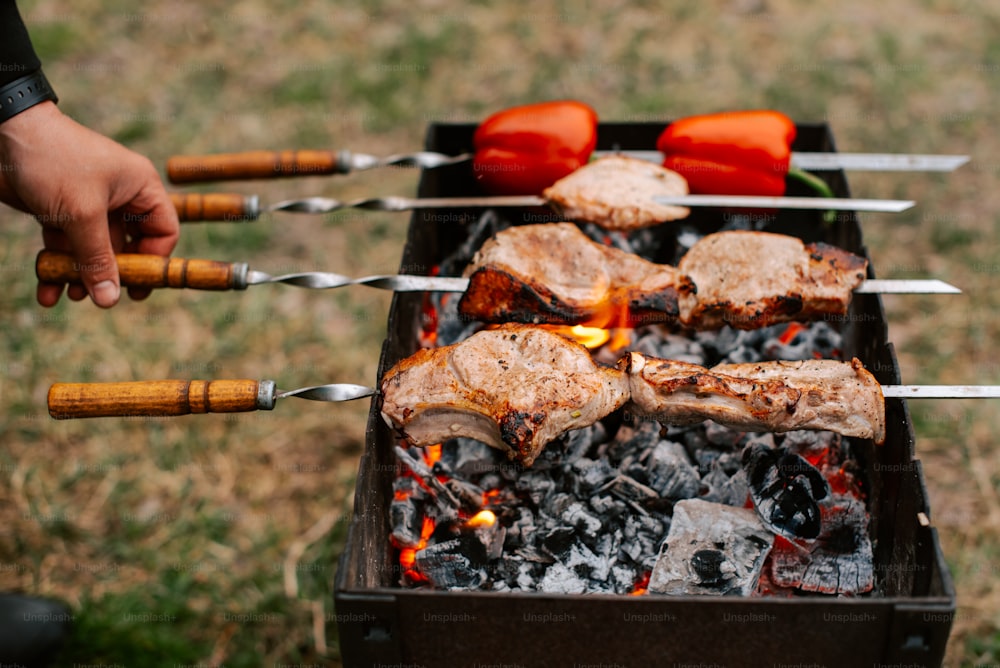 a grill with meat and vegetables cooking on it