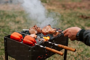 a person is cooking food on a grill