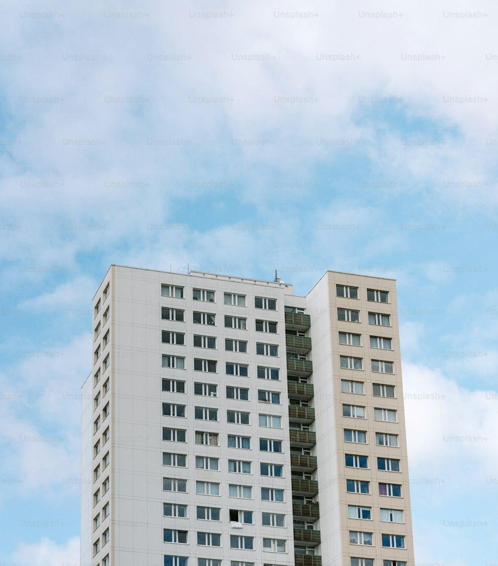 a tall white building sitting next to a tall white building