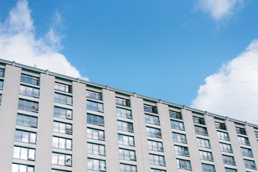 a tall building with lots of windows under a blue sky