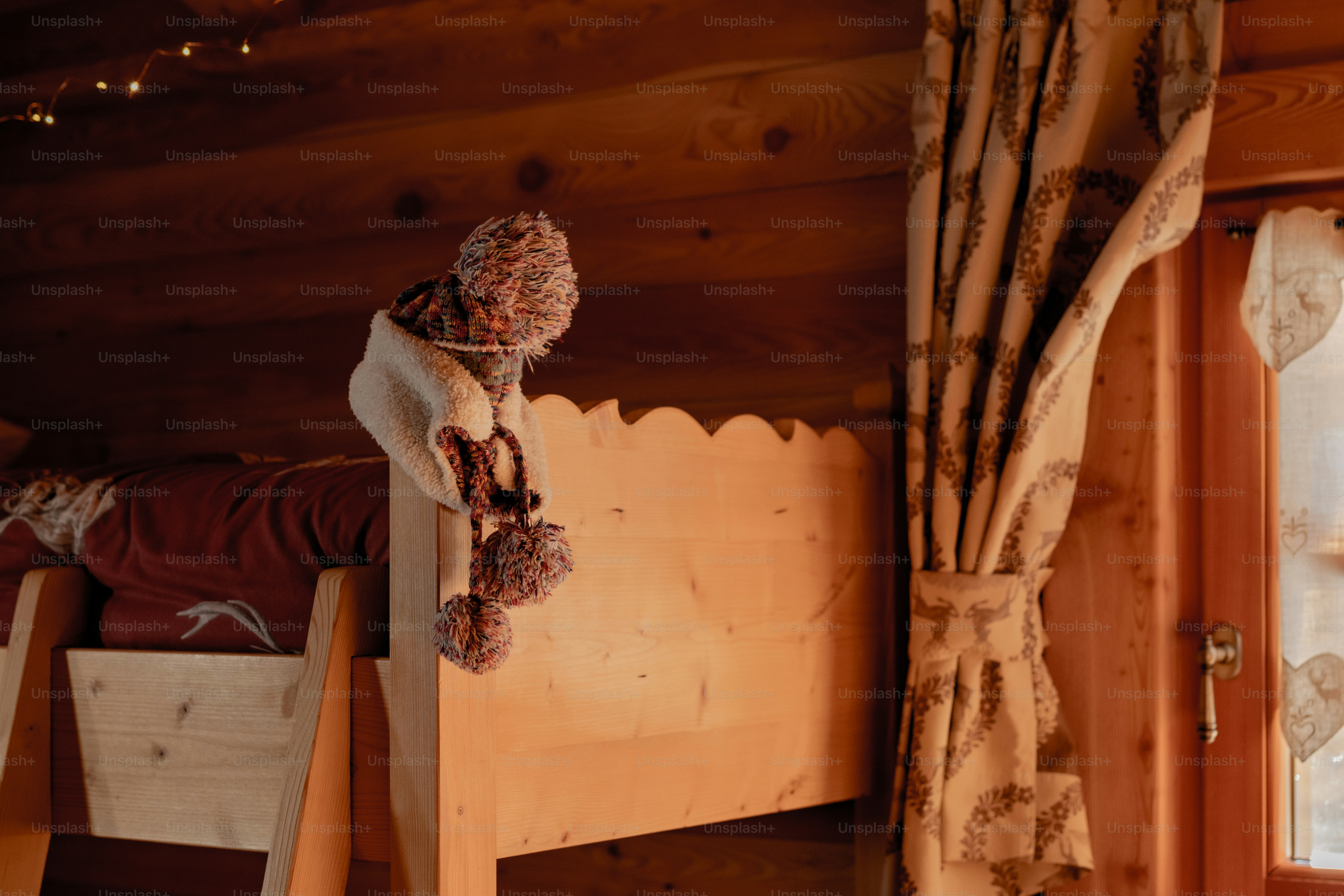 a wooden bunk bed with a scarf on top of it