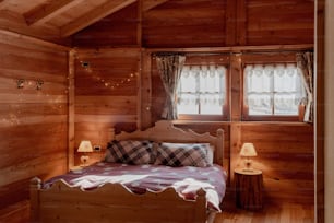 a bed in a room with wooden walls