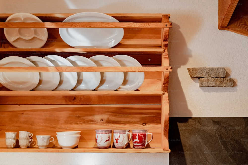 a wooden rack with plates and cups on it