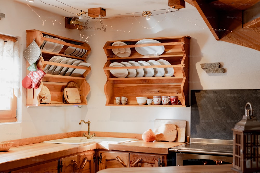 a kitchen with wooden shelves filled with dishes