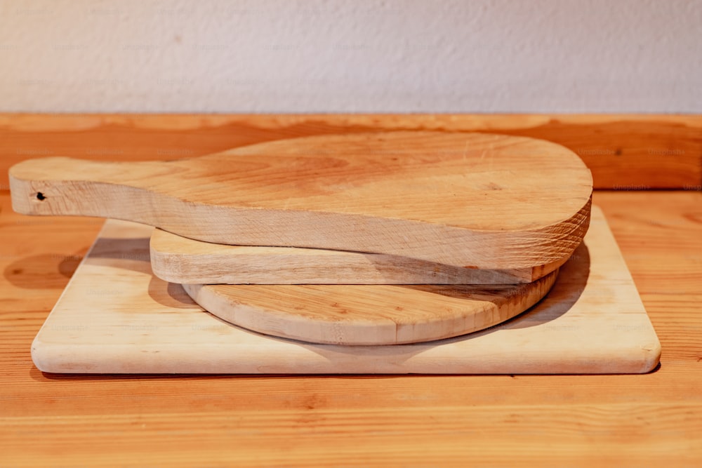 a couple of wooden cutting boards sitting on top of a wooden table