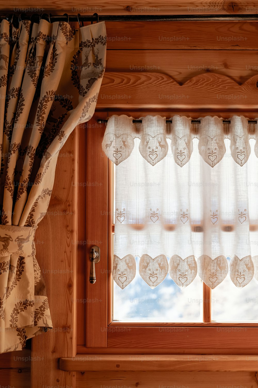 a window with a curtain and a window valance
