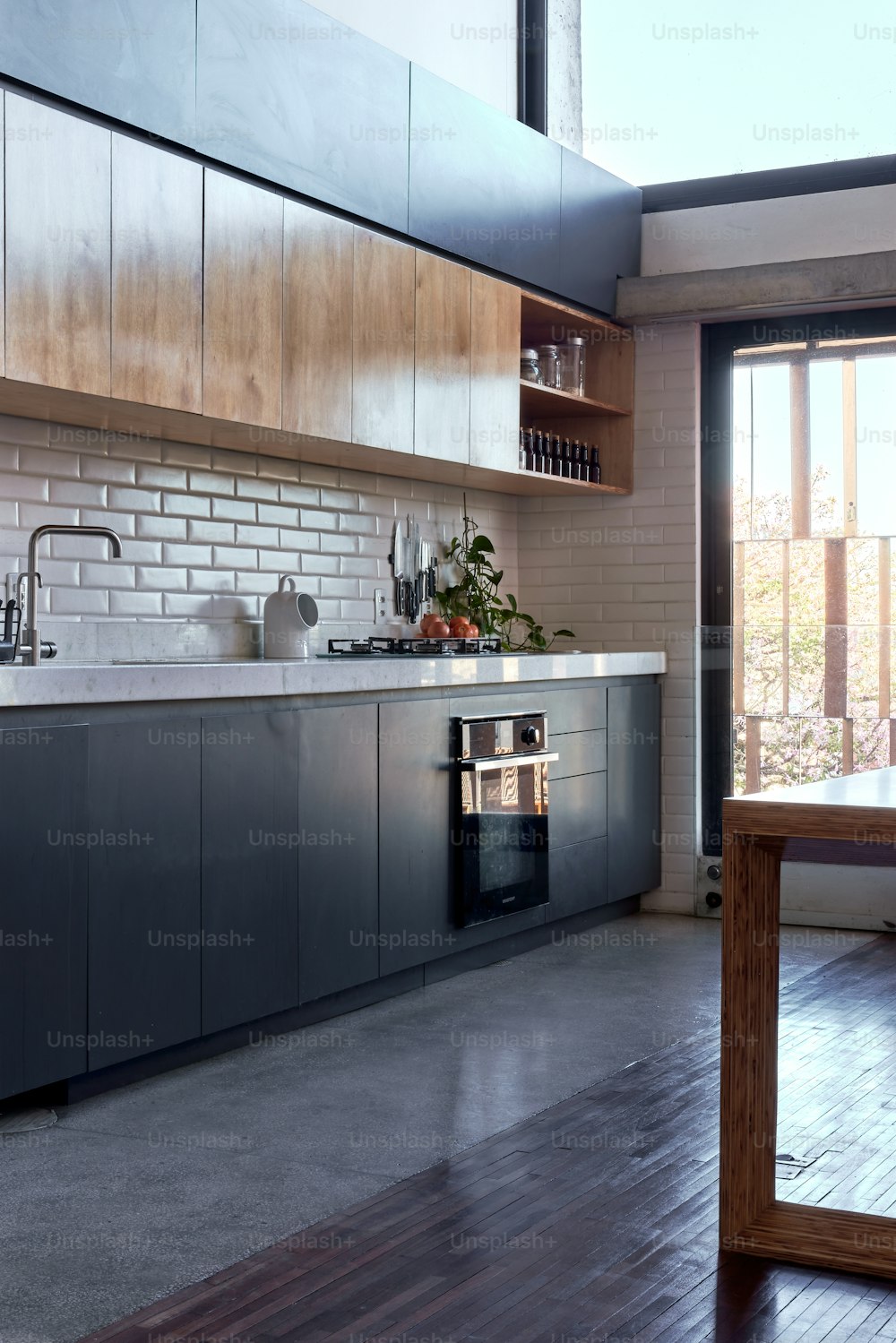 a kitchen with a stove, sink, cabinets and a table