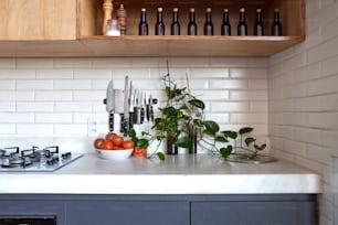 a kitchen counter topped with a bowl of fruit and vegetables