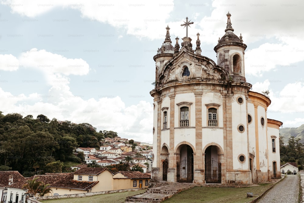 an old church with a steeple on a hill