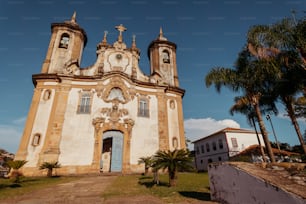 an old church with two towers and a blue door