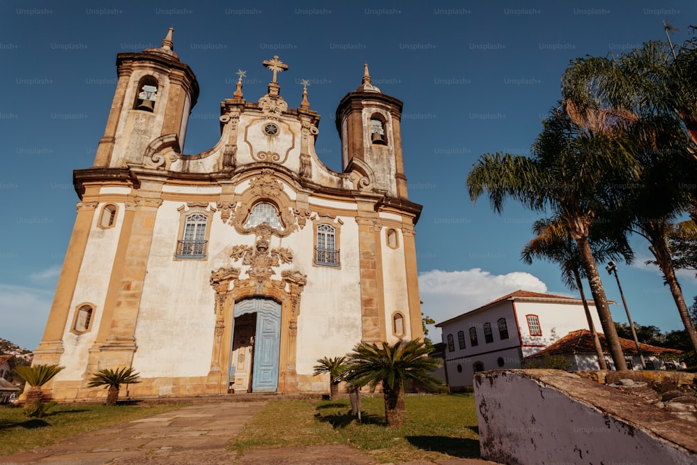 an old church with two towers and a blue door