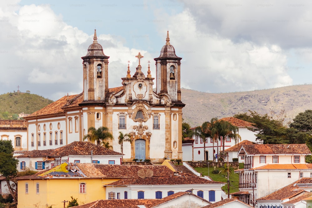 a large church with a clock tower in the middle of a town