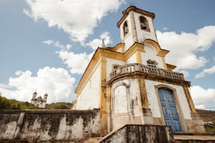 an old church with a steeple and a blue door