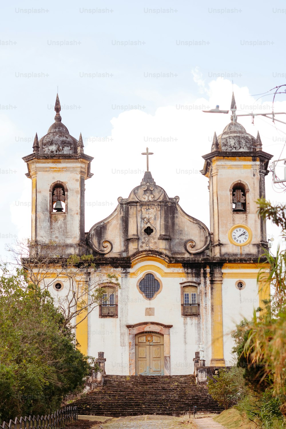 a large white and yellow building with two towers