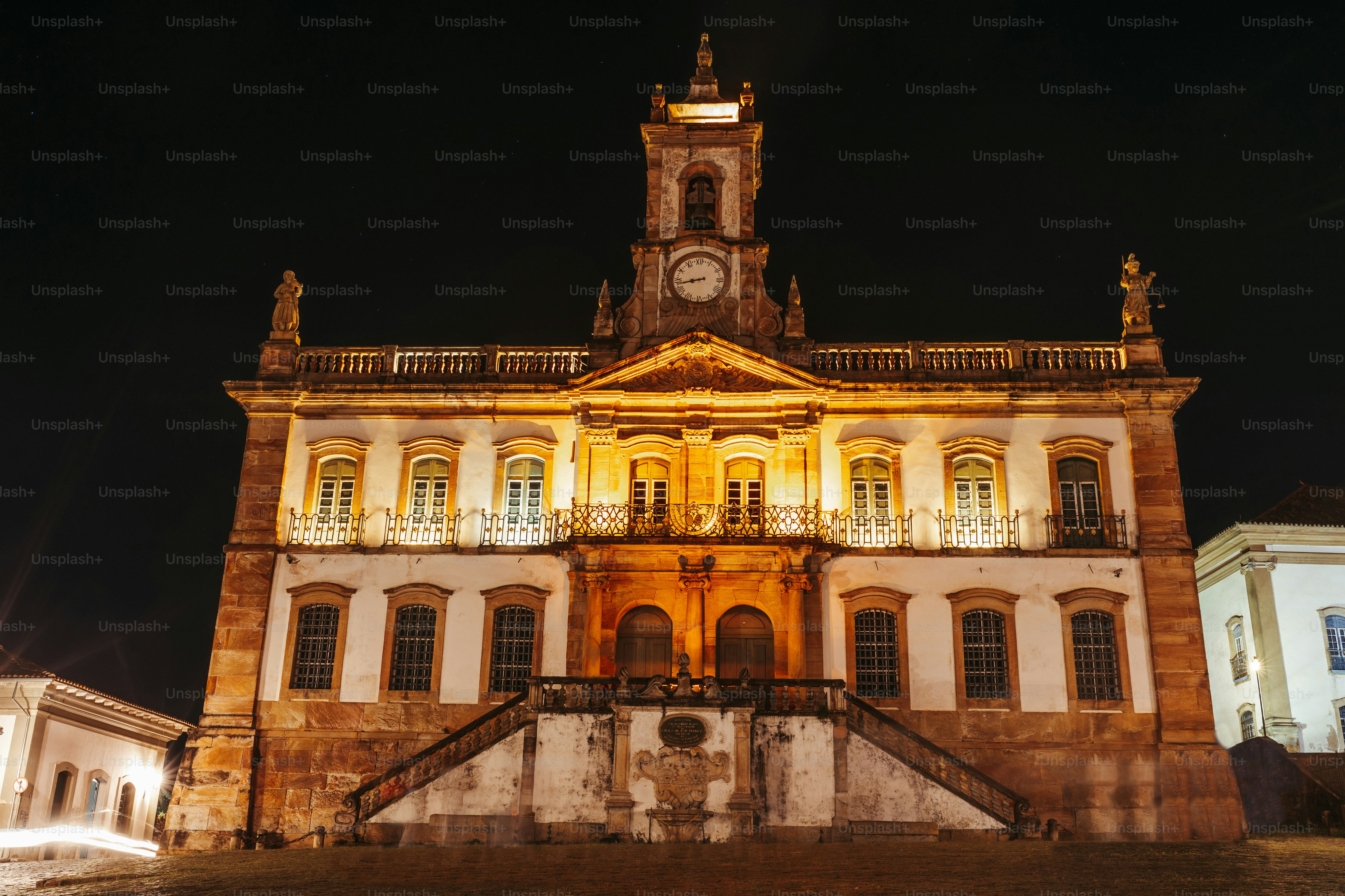 a large building with a clock tower at night