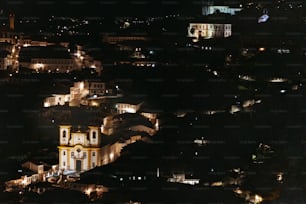 a view of a city at night from a hill