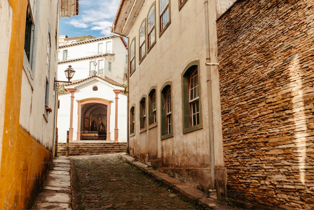 a narrow alley way with a church in the background