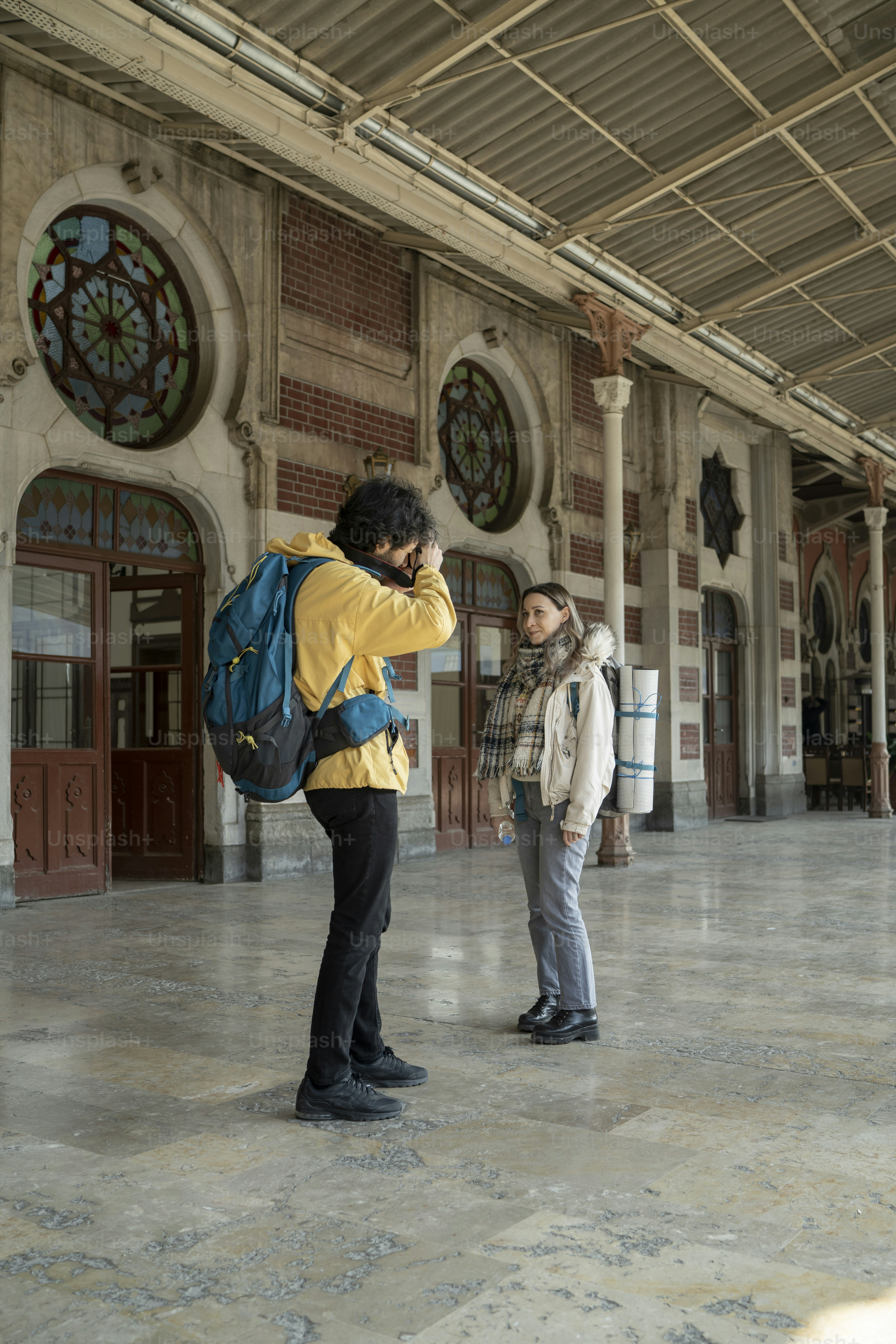 a man and a woman standing in front of a building