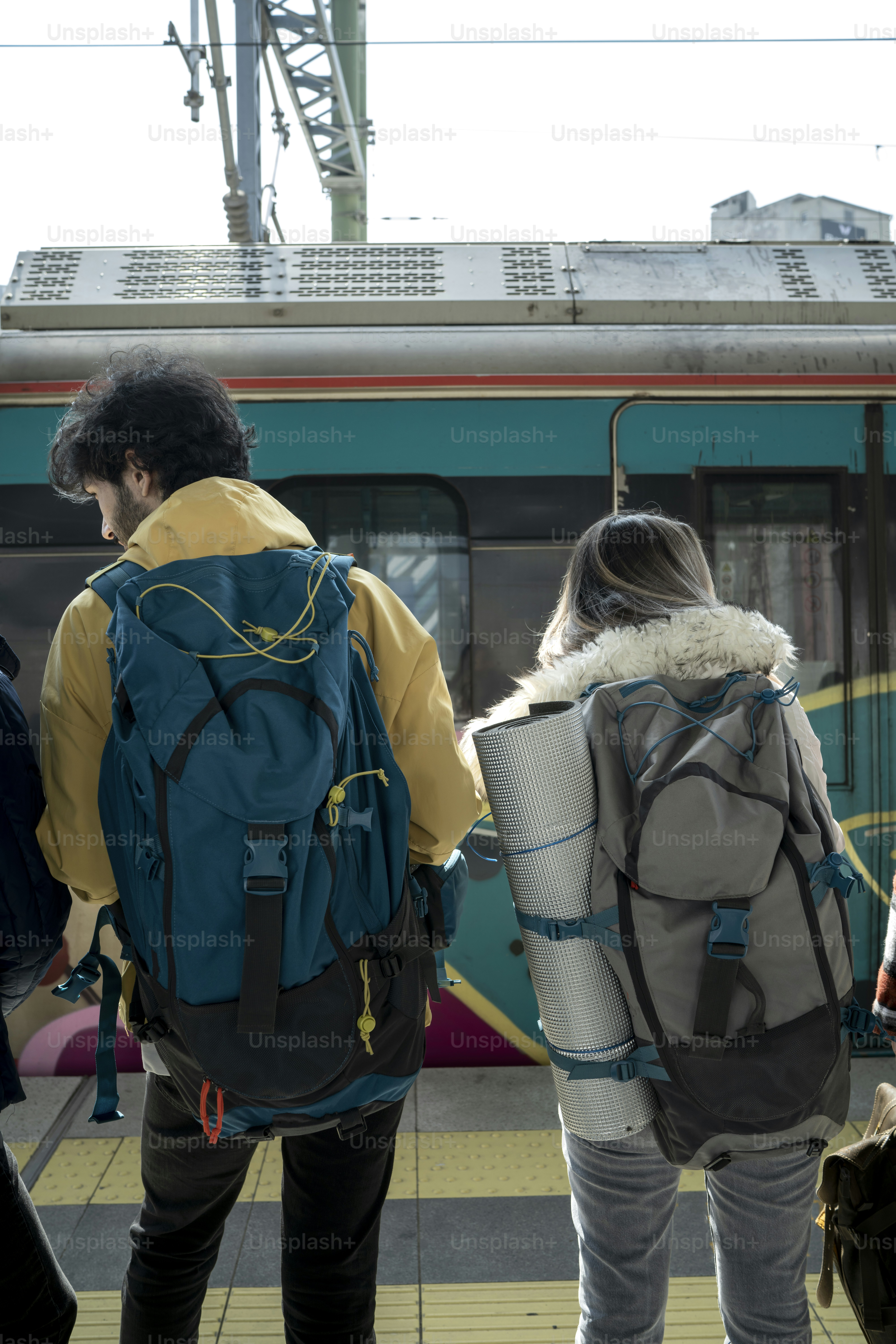 a group of people standing next to a train