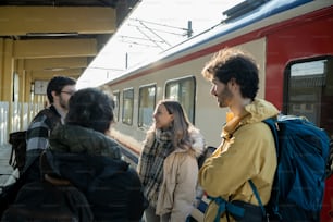 a group of people standing next to a train