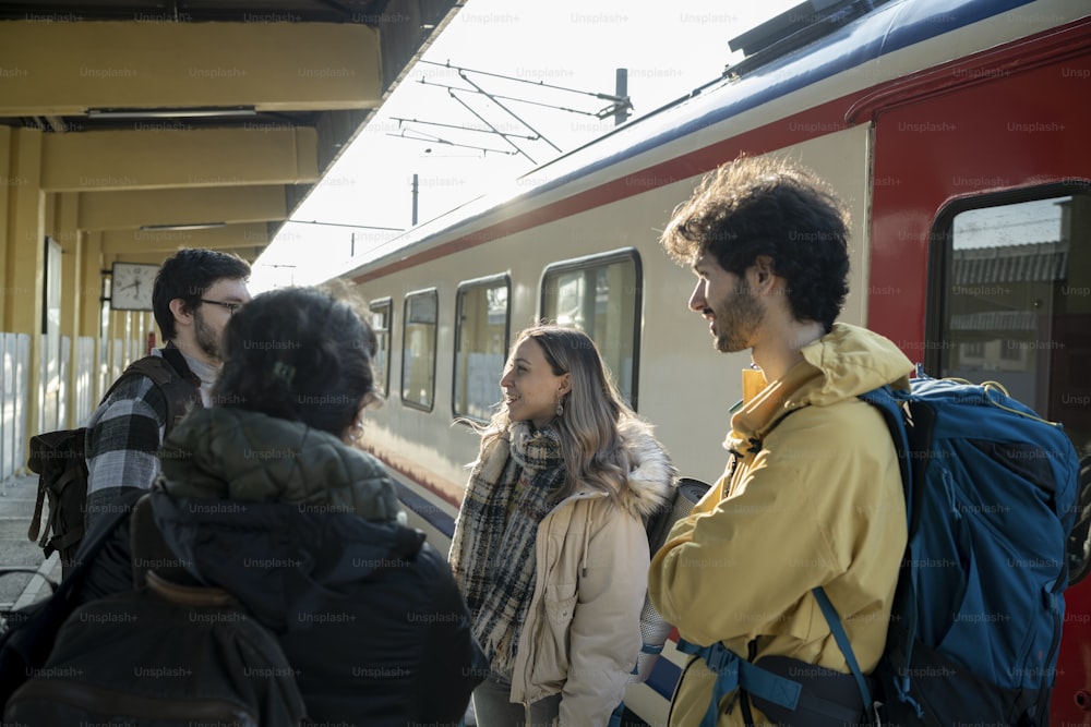 a group of people standing next to a train