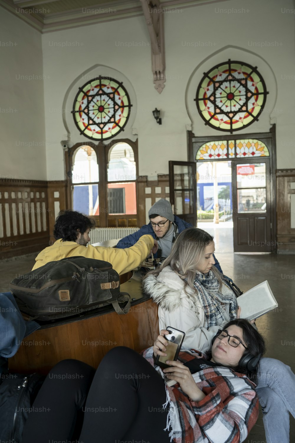 a group of people sitting on a bench in a building