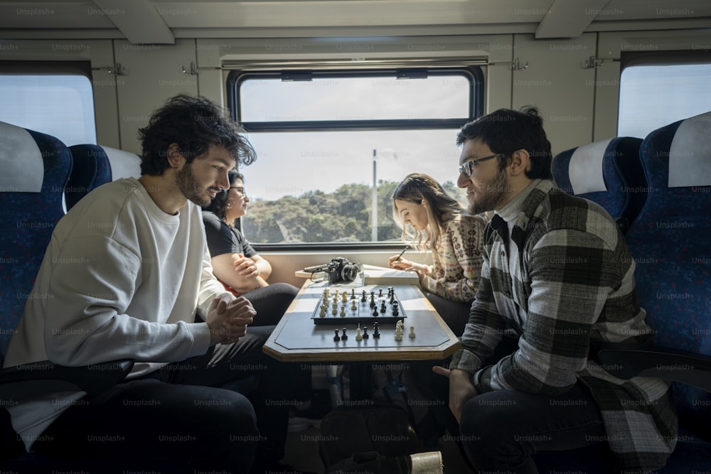 a group of people playing chess on a train