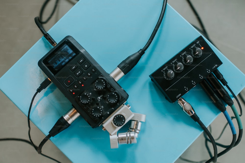 two electronic devices sitting on top of a blue table