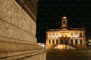 a large building with a clock tower at night