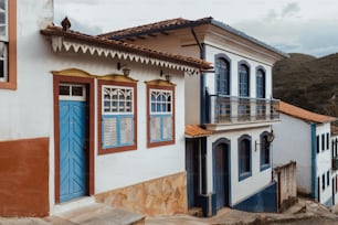 a white building with blue doors and windows