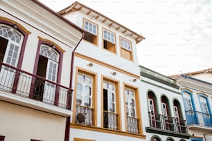 a row of multicolored buildings with balconies