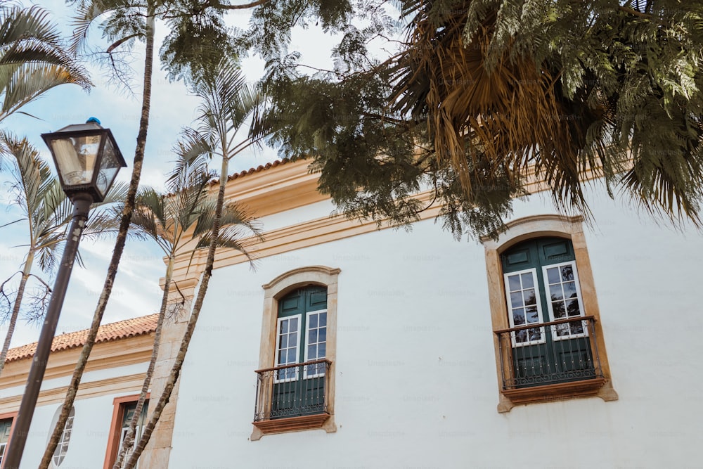 a white building with two windows and a street light