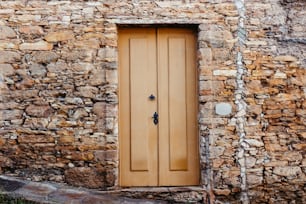 a stone building with a wooden door and window