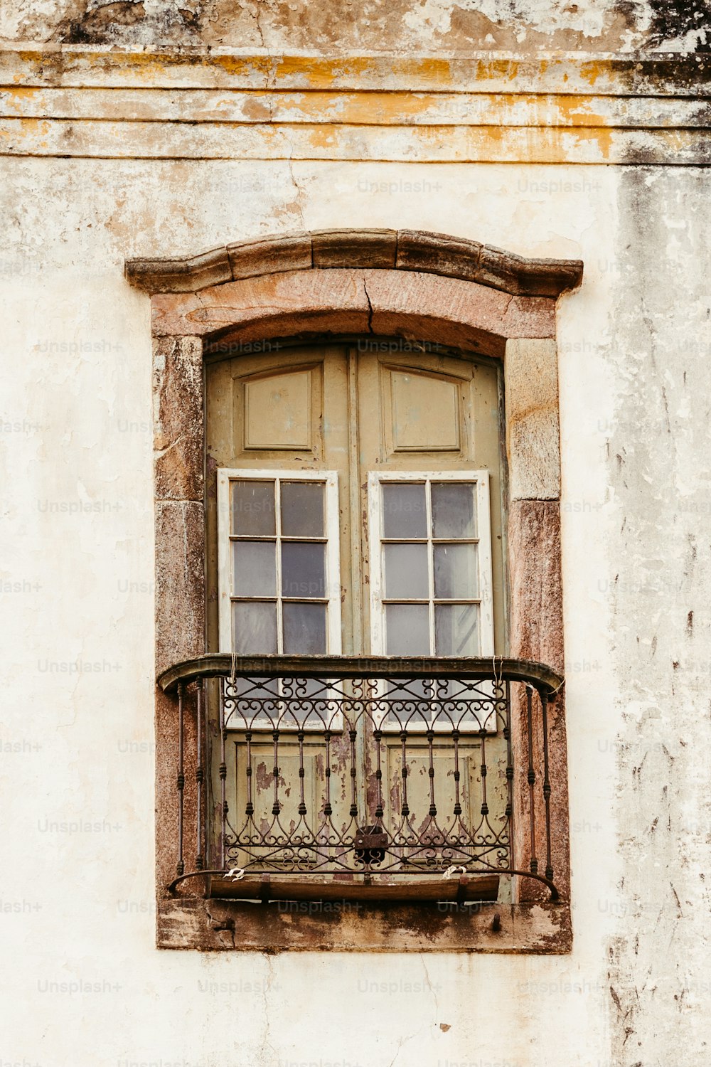 a balcony with a balcony railing and two windows