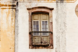 an old building with a window and a balcony