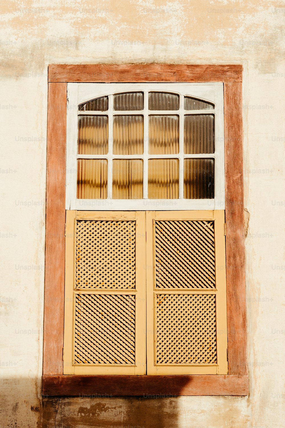 a window on a wall with a wooden frame