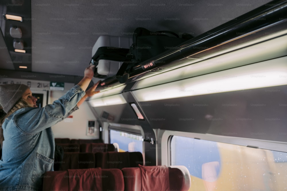 a man in a blue jacket and a hat on a train