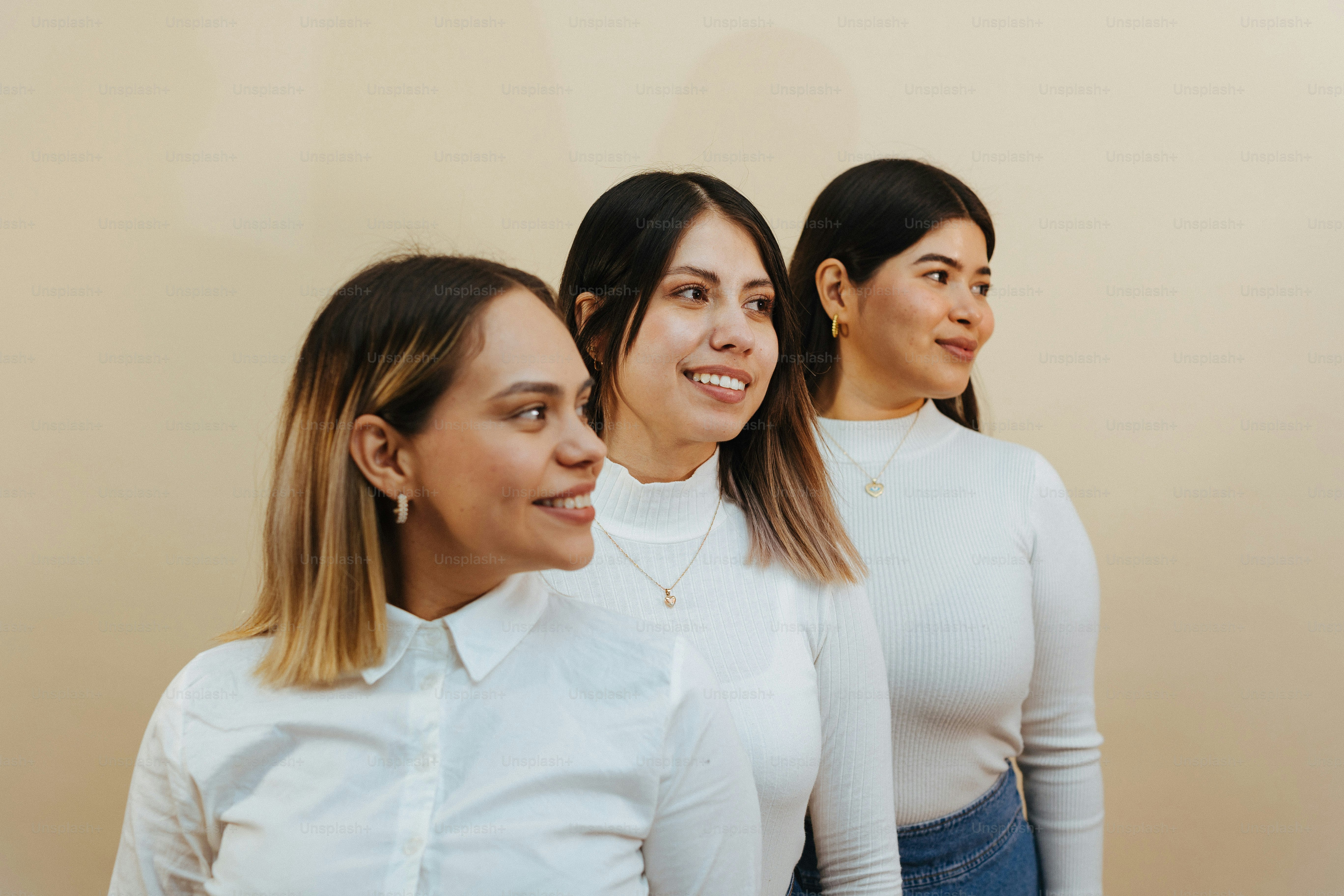 a group of three women standing next to each other