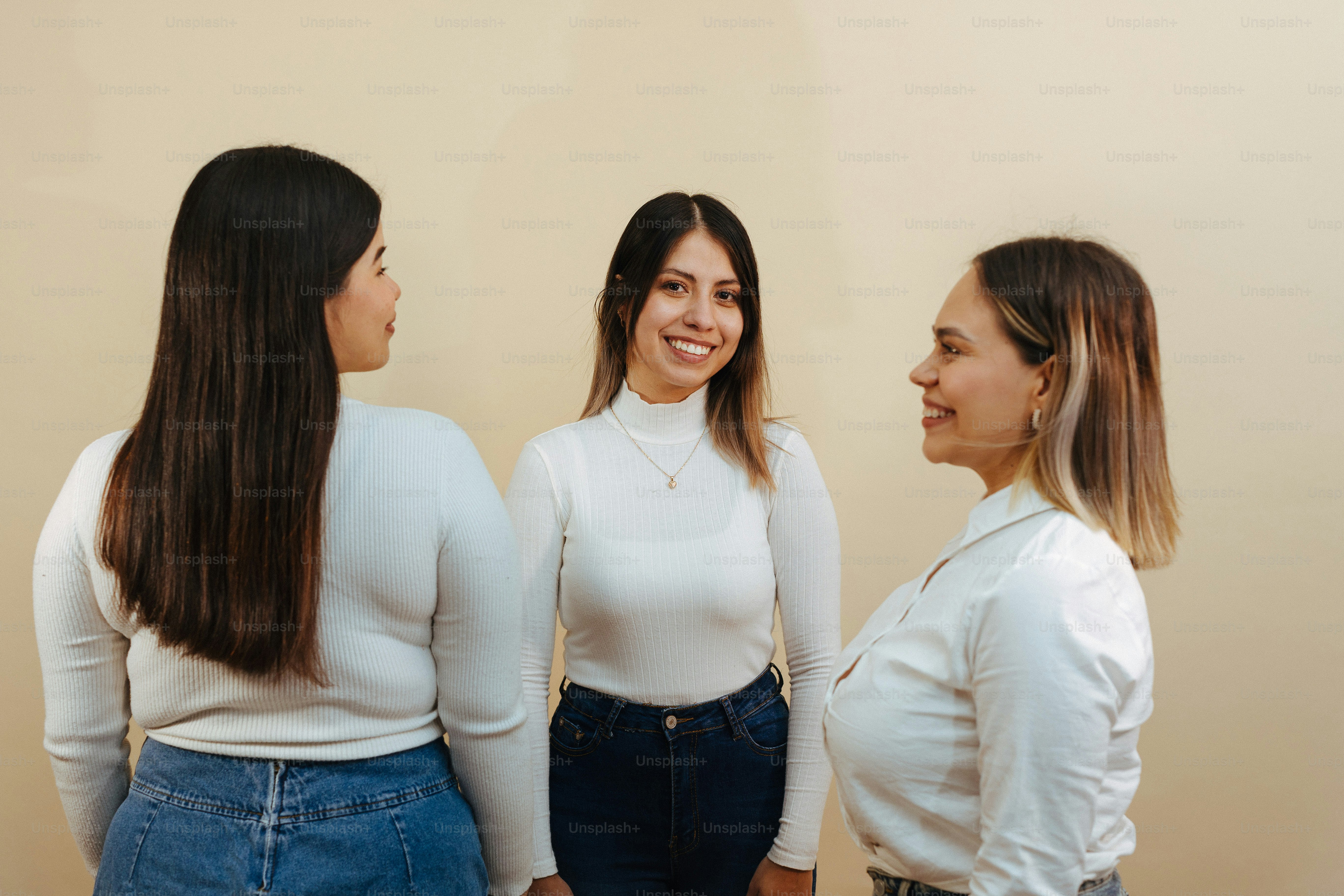 a group of three women standing next to each other