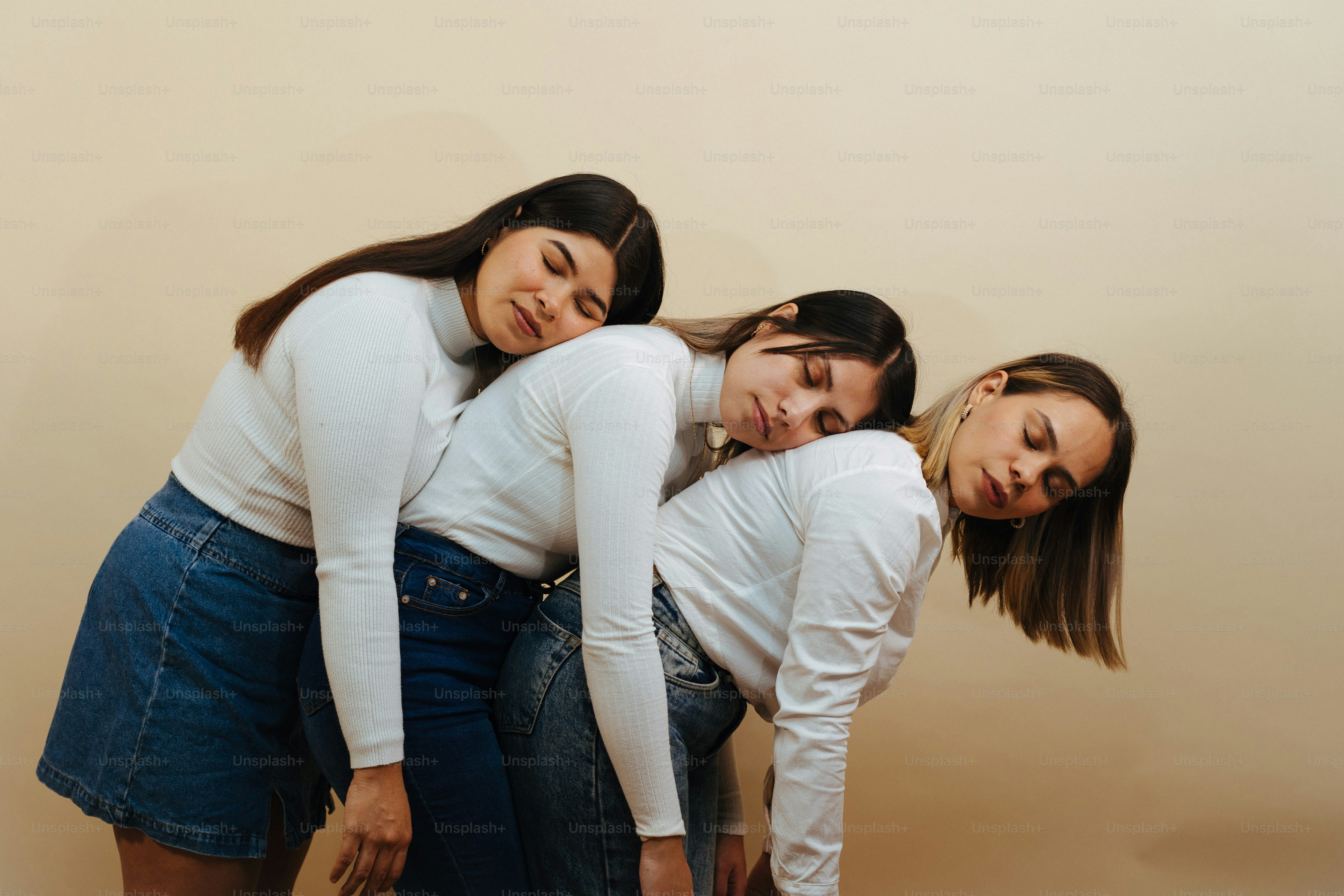 a group of three women standing next to each other