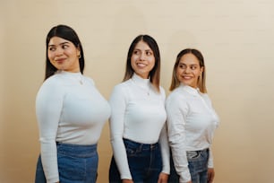a group of three women standing next to each other