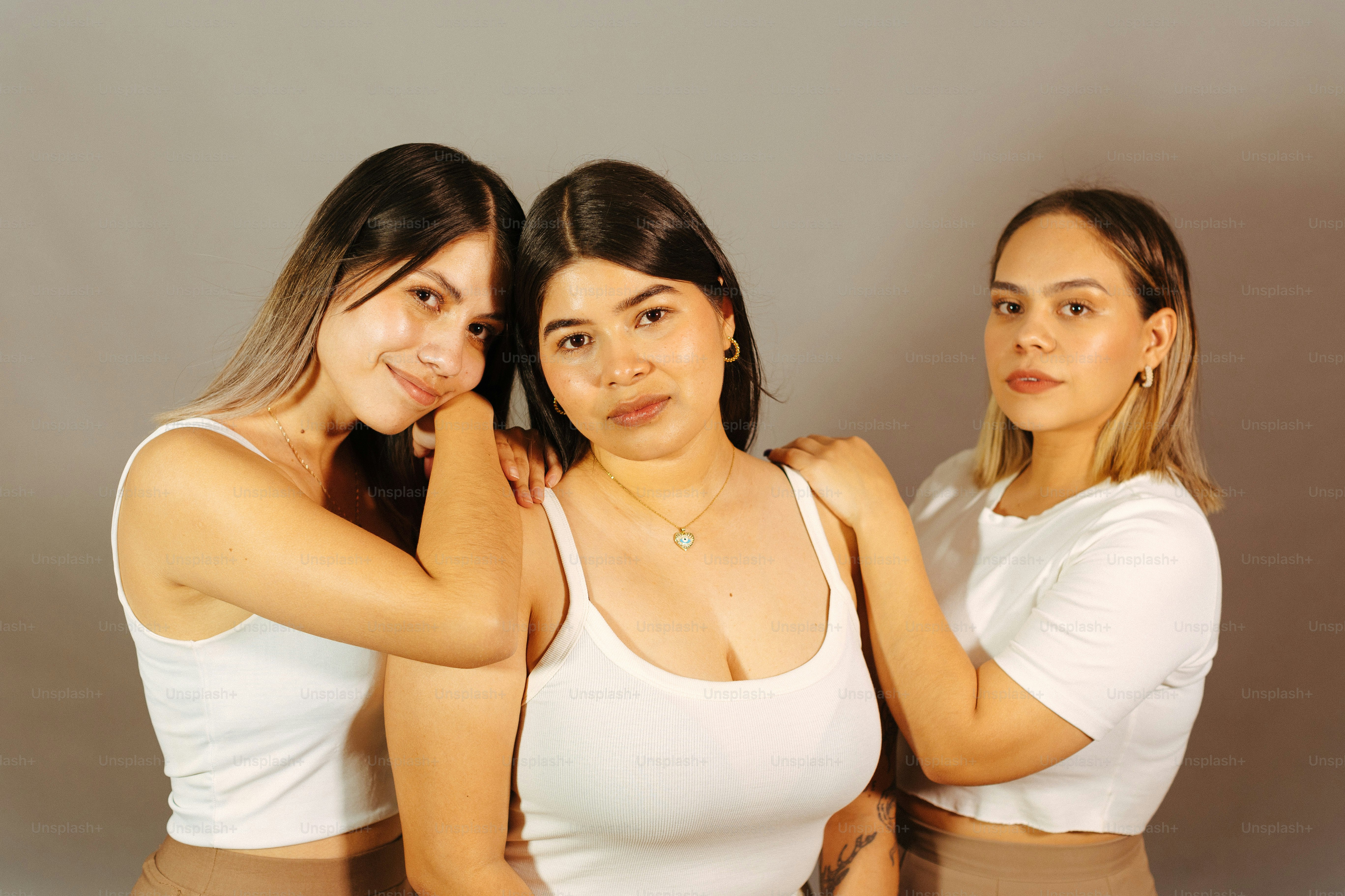 a group of three women standing next to each other