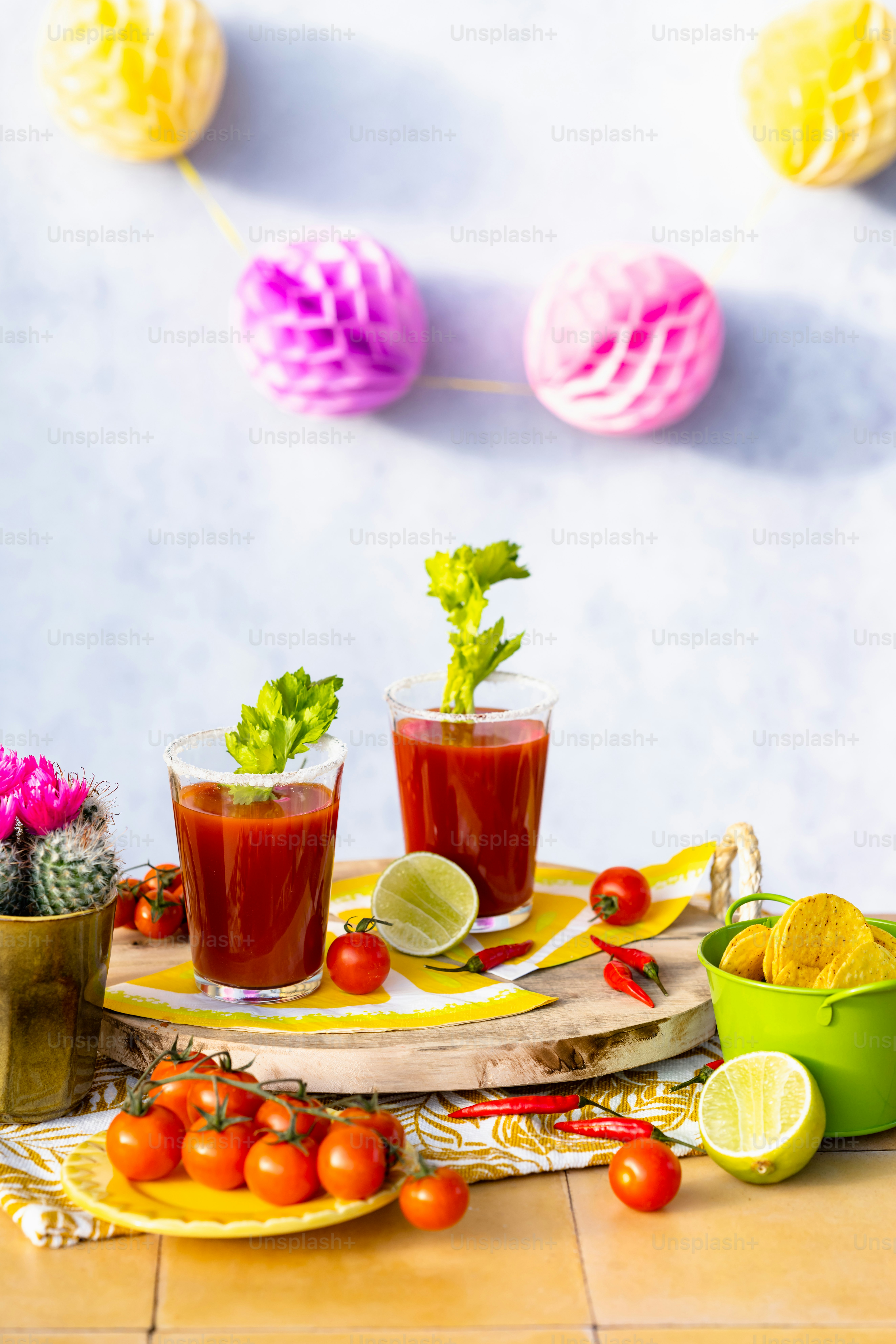 a table topped with two glasses filled with drinks