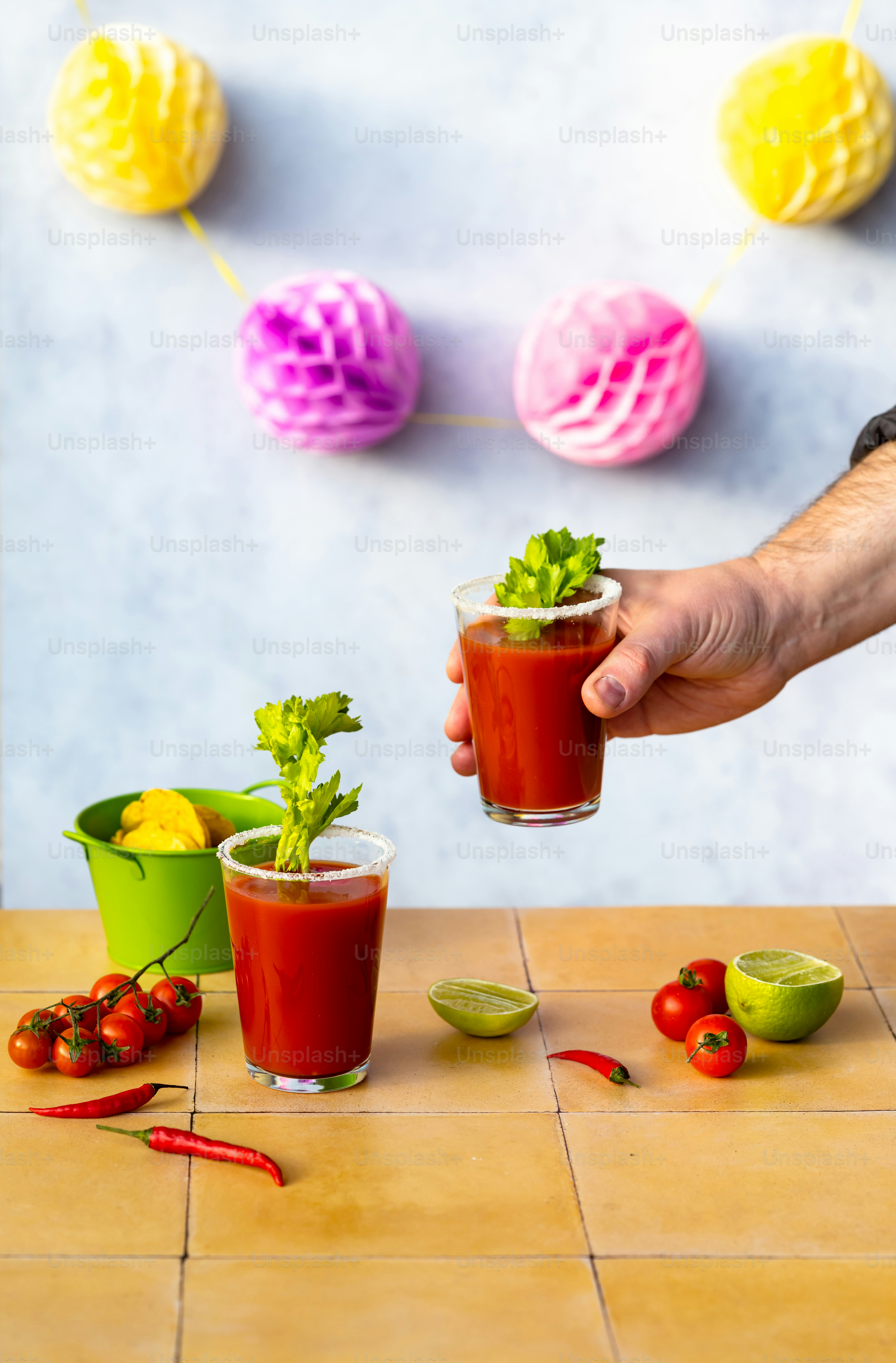 a person is holding a glass with a drink in it