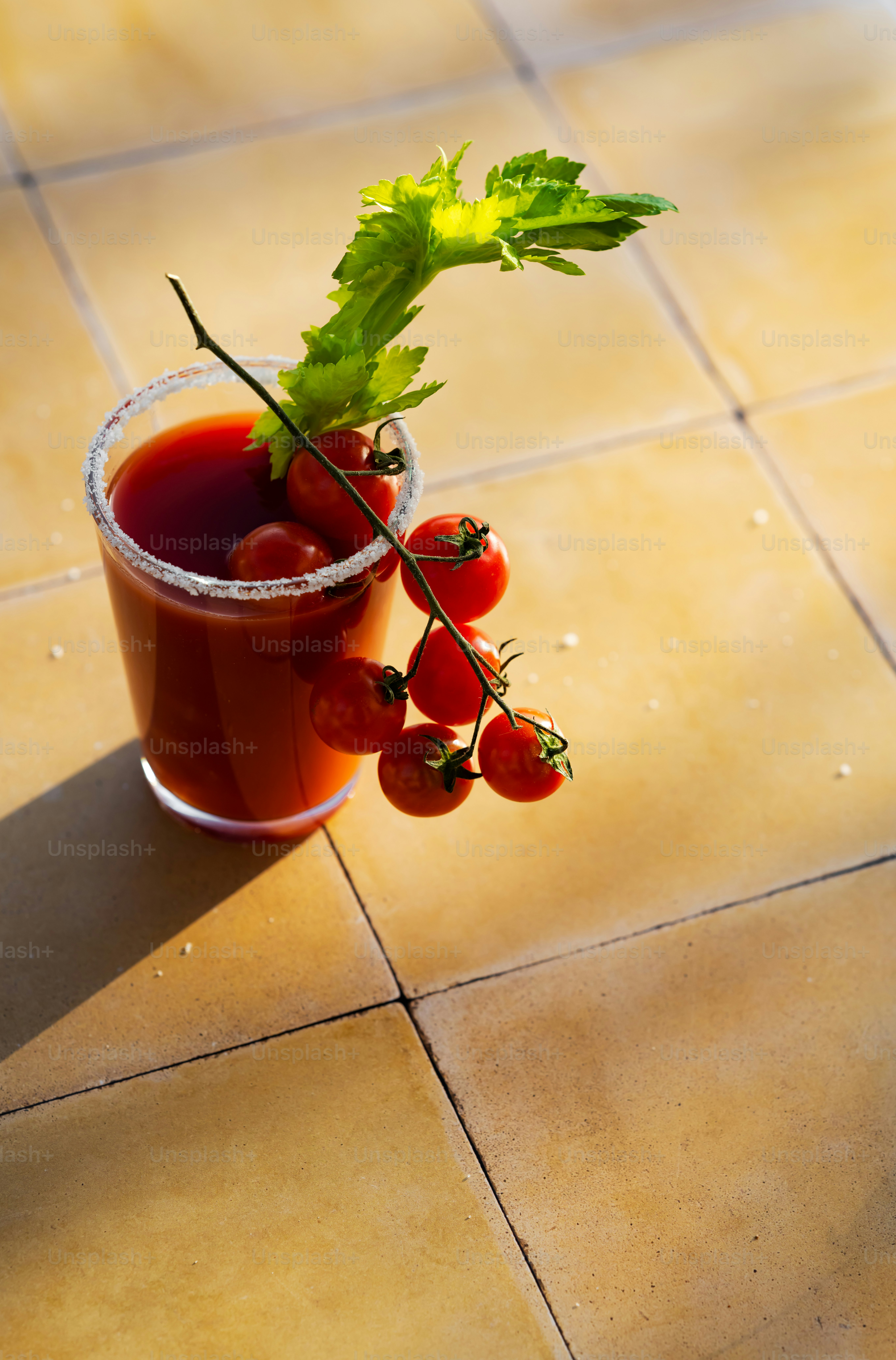 a cup filled with a drink sitting on top of a tiled floor