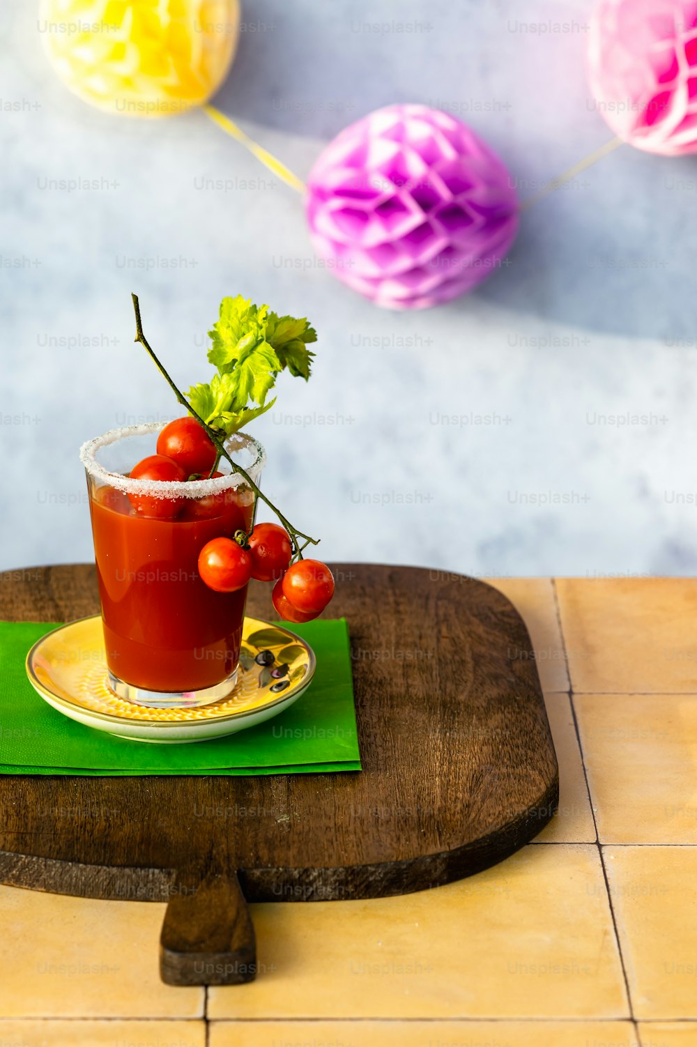 a bloody drink with cherry tomatoes on a plate