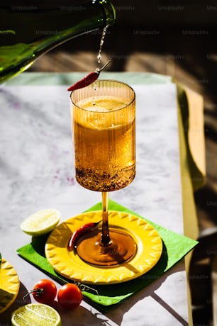 a drink being poured into a glass on a yellow plate