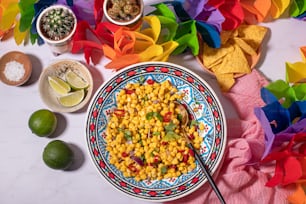 a colorful plate of food with a spoon