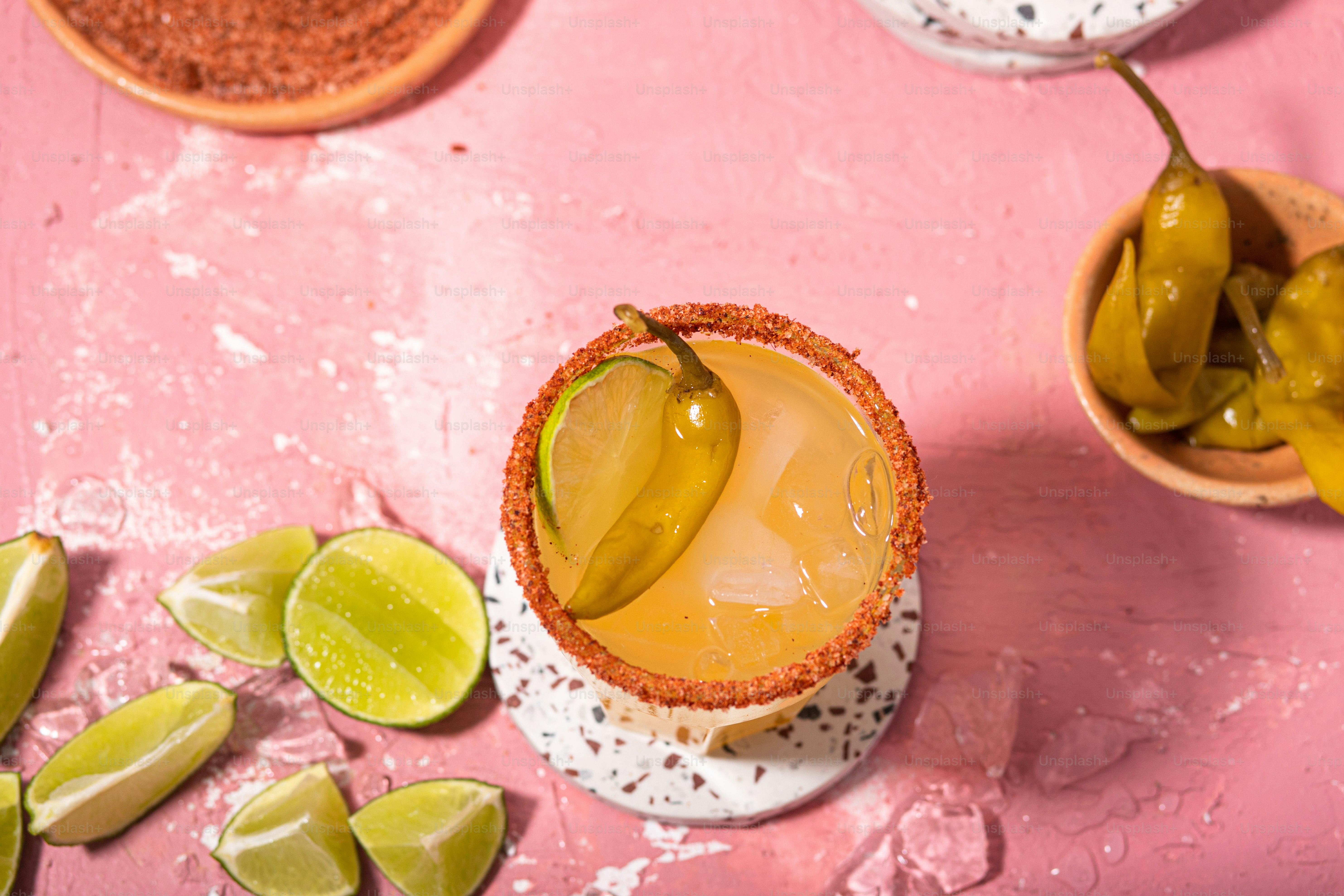 a drink in a glass with a lime slice on the rim