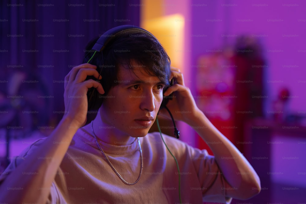 a young man listening to music with headphones